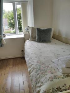 a bed in a room with a window at The Lodge in Masham