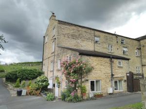 a large brick building with flowers on it at The Lodge in Masham