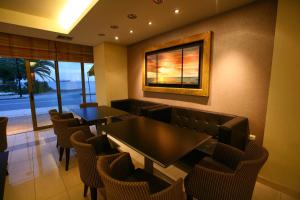 a restaurant with tables and chairs and a picture on the wall at Hotel Flisvos in Kalamata