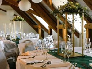 a dining room with white tables and wine glasses at SWISS HOTEL LA COURONNE in Avenches