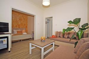 a living room with a couch and a table at Akti Kalogria Hotel in Kalogria