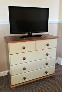 a dresser with a tv on top of it at Ashfields in Llandudno