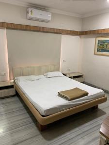 Ένα ή περισσότερα κρεβάτια σε δωμάτιο στο Ballygunge Guest House