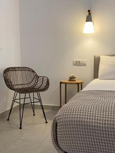 a bedroom with a bed and a chair and a lamp at Margarita Guesthouse in Apollonia