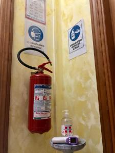 a fire extinguisher is hanging on a wall at Alloggio turistico Luigina in Morro Reatino
