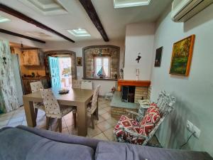 a living room with a couch and a table and a fireplace at Manolis House in Lefkada