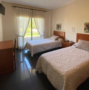a hotel room with two beds and a window at Hotel Pedramar in A Lanzada +19 photos