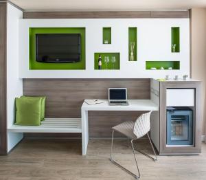 a desk with a laptop and a chair in a room at Enjoy Garda Hotel in Peschiera del Garda