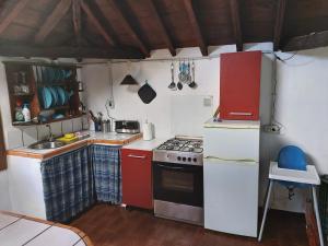 a small kitchen with red and white appliances at Finca Cueva del Viento in Icod de los Vinos