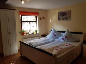 a bedroom with a bed with pillows and a window at Zum Burgtörle in Walldürn