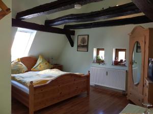 a bedroom with a wooden bed and a mirror at Zum Burgtörle in Walldürn