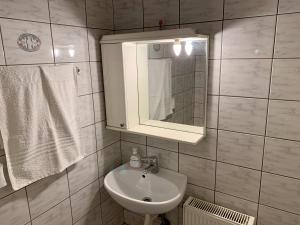 a bathroom with a sink and a mirror and towels at Zygas House in Ágios Nikólaos