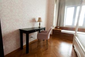a bedroom with a desk and a chair and a window at Profolio @ Straits Quay in George Town
