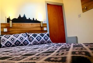 a bedroom with a bed with a wooden head board at The Liverpool Pod Travel Hostel in Liverpool
