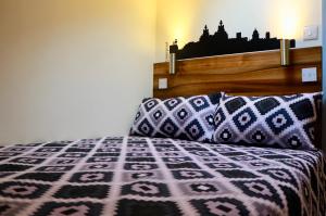 a bedroom with a bed with a purple and white blanket at The Liverpool Pod Travel Hostel in Liverpool