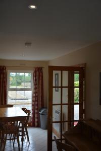 a dining room with a table and a window at Killarney Country Club in Faha