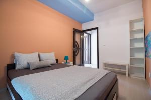 a bedroom with a large bed with orange walls at sweet house in Arad