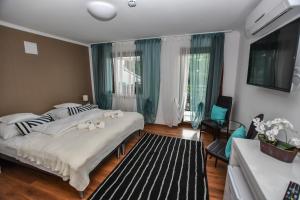 a bedroom with two beds and a living room at É-Vaskó Panzió Borpince in Tokaj