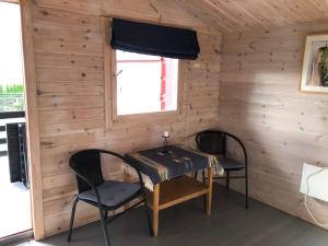 a room with a table and two chairs and a window at Haugo utleige lodge in Vossevangen