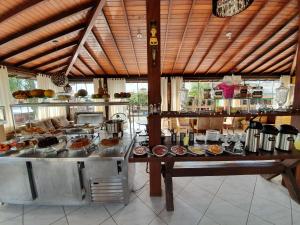 a kitchen with a table with food on it at Pousada Maunaloa in Garopaba