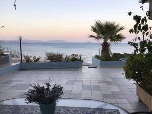 a patio with a view of the ocean at Seaside apartment in Xiropigado