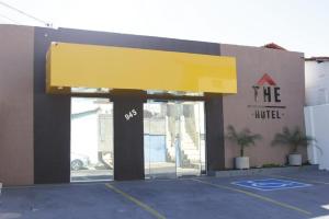 a store with a yellow awning in a parking lot at The Hotel in Teresina
