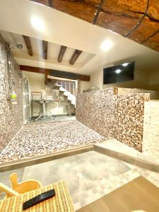 a room with a stone wall and a table and chairs at ABCdecor Italia in Imperia