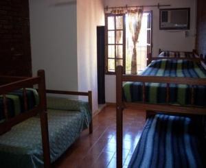 a bedroom with two bunk beds and a window at El Guembe Hostel House in Puerto Iguazú