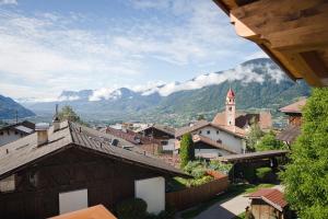 a view of a village with mountains in the background at Haller Hof in Tirolo