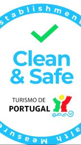 a sign for a dental clinic with a green arrow and the words clean safe at Scented House in Porto