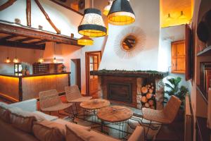 a living room with a couch and a fireplace at VILASIRA ( Rooms & Wines ) in Los Cojos