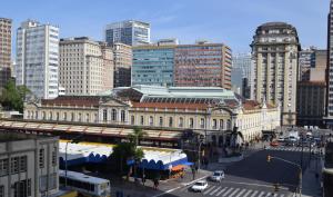 a large building with a train station in a city at Hotel Scala in Porto Alegre