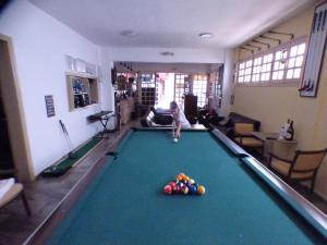 a young child playing with a pool table at Eleni Apartments in Hersonissos