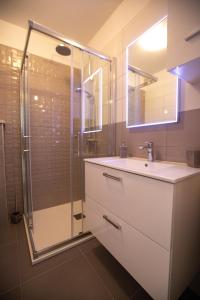 a bathroom with a sink and a glass shower at Dimani in Split