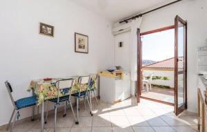 a kitchen with a table and chairs and a window at Apartments Luna in Zubovići