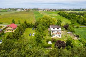 an aerial view of a house on a green field at Agroturystyka Lubaczówka in Sarbinowo