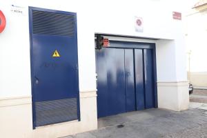 a building with a blue door with a danger sign on it at Duplex Santa Teresa in Córdoba