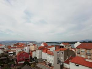 a view of a city with red roofs at Apartamentos O Grove in O Grove