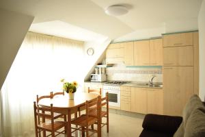 a kitchen with a table and chairs in a room at Apartamentos O Grove in O Grove