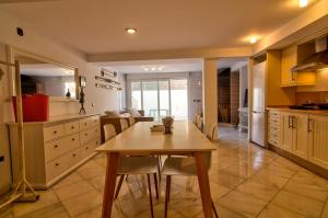 a kitchen with a table and chairs in a room at Altair 11 in El Puerto de Santa María +29 photos