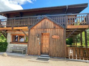 a large wooden building with a large deck at Chalet d' Annelise in Gérardmer