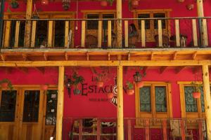 a red brick building with a red door at Hotel La Estacion in Creel