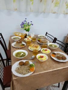 a table with plates of food on it at Hotel Irina in Gribovka