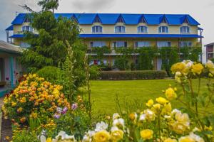 a large house with a lot of flowers in front of it at Hotel Irina in Gribovka