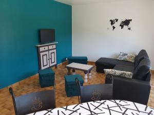 a living room with a couch and a table at La Quietude in Amboise