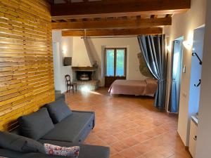 a living room with a couch and a bed at Sant Andrea Country Cottage in Barberino di Mugello