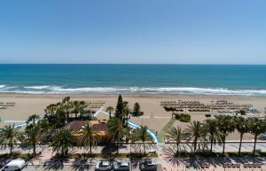 a view of the beach from the balcony of a resort at Hotel Apartamentos Bajondillo in Torremolinos