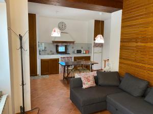 a living room with a couch and a table at Sant Andrea Country Cottage in Barberino di Mugello