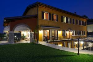 una casa con una piscina delante de ella por la noche en Agriturismo Bacche di Bosco, en Verona