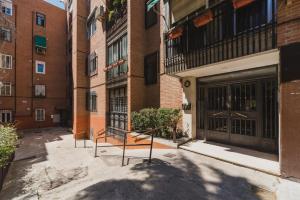 a building with doors and stairs in a courtyard at Sunlit cosy haven a spacious treasure to be discovered in Madrid